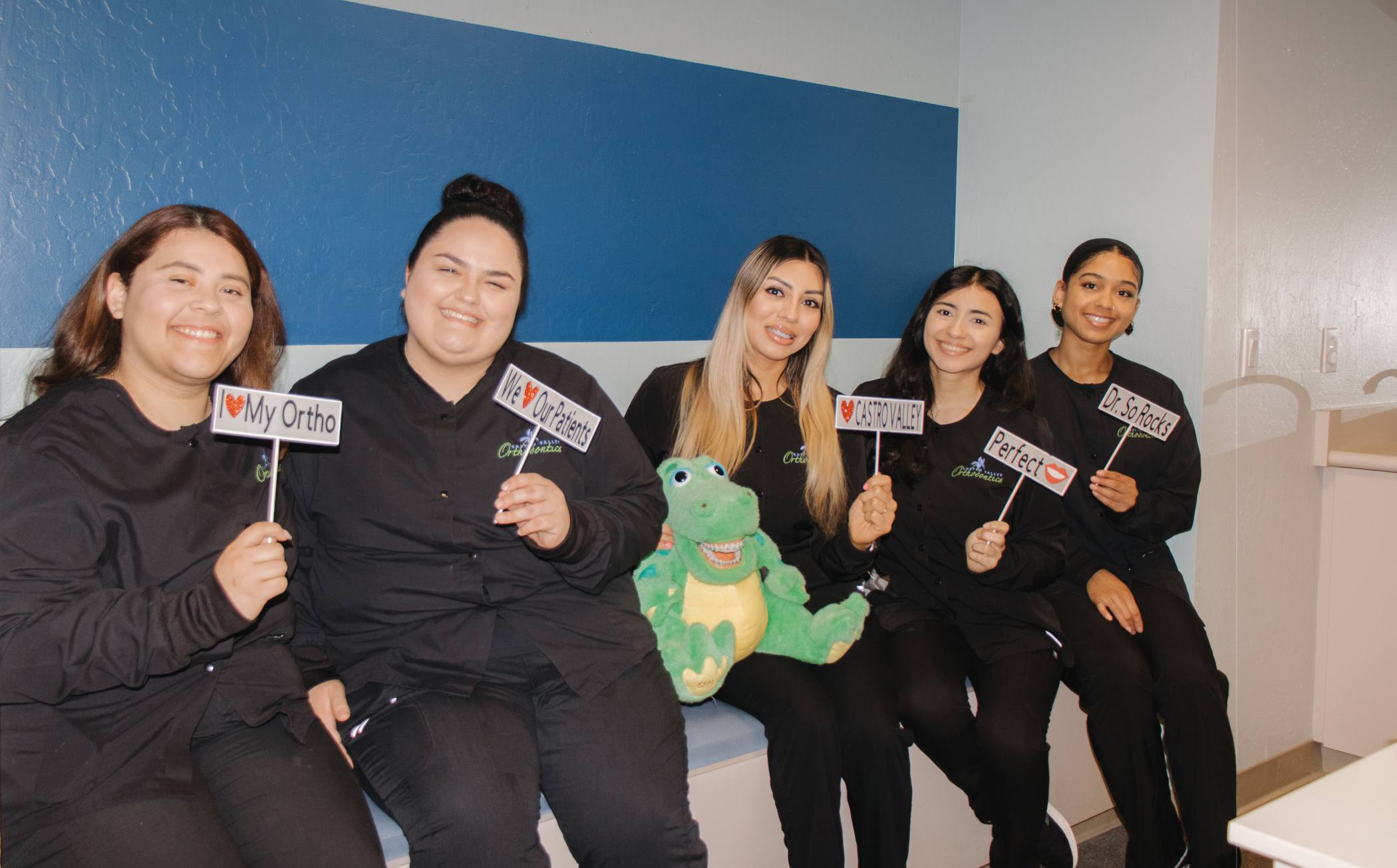 Team members holding up signs